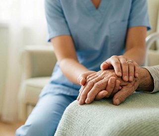 Nurse holding patients hand