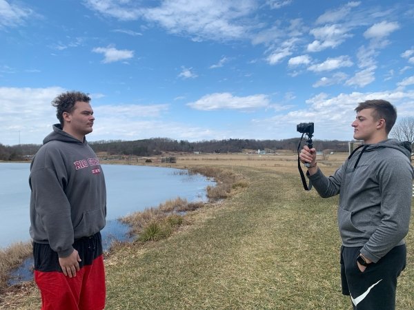 students film outside near pond