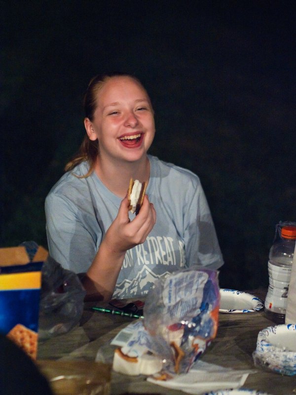 Students smile while eating smores