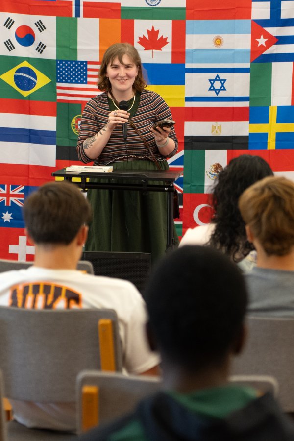 Female student reading at Words of the World Event