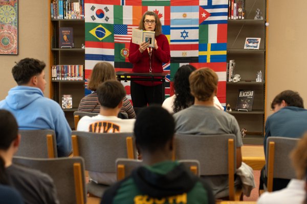 Professor reading to students at Words of the World Event